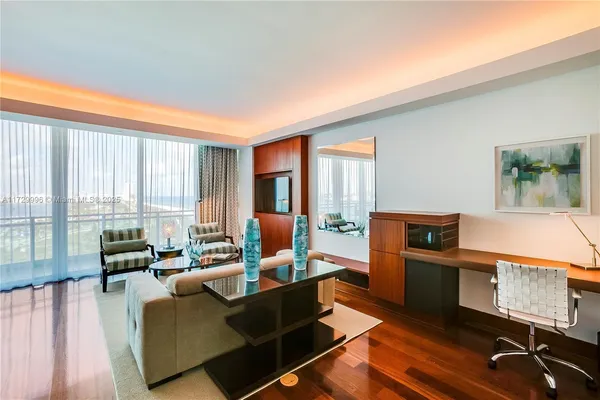 a living room with furniture city view and large windows