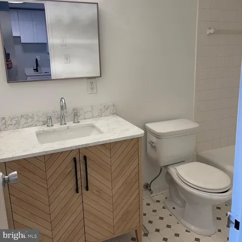a bathroom with a sink a toilet and mirror