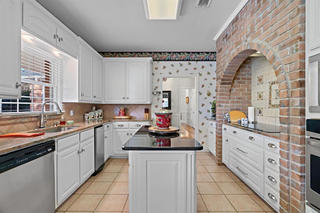 72 Crown Road Willow Park, TX 76087 - Photo 13 of 40 a kitchen with stainless steel appliances a sink stove and cabinets