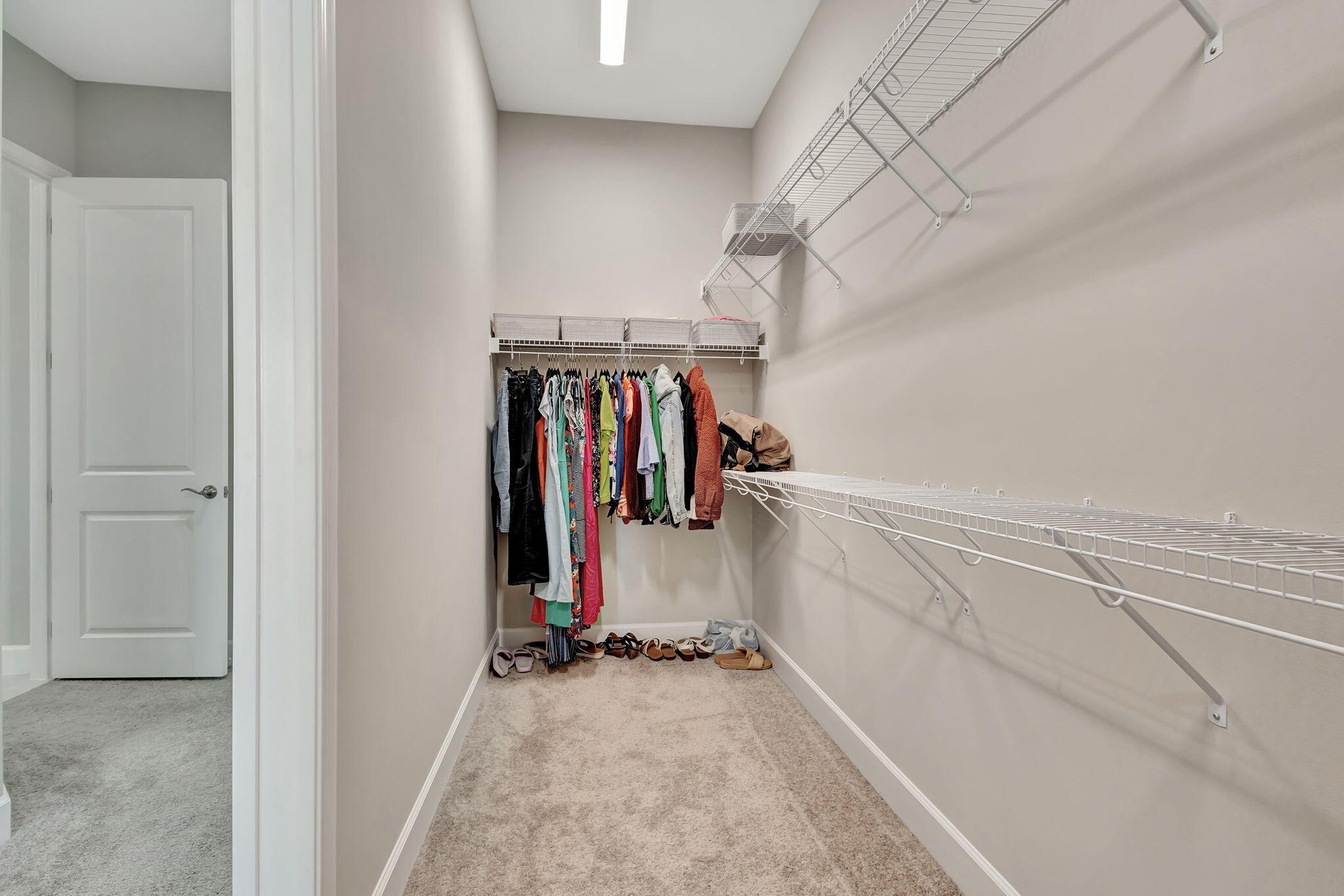 5403 Macoon Way Westlake, FL 33470 - Photo 18 of 51 a view of walk in closet with clothes