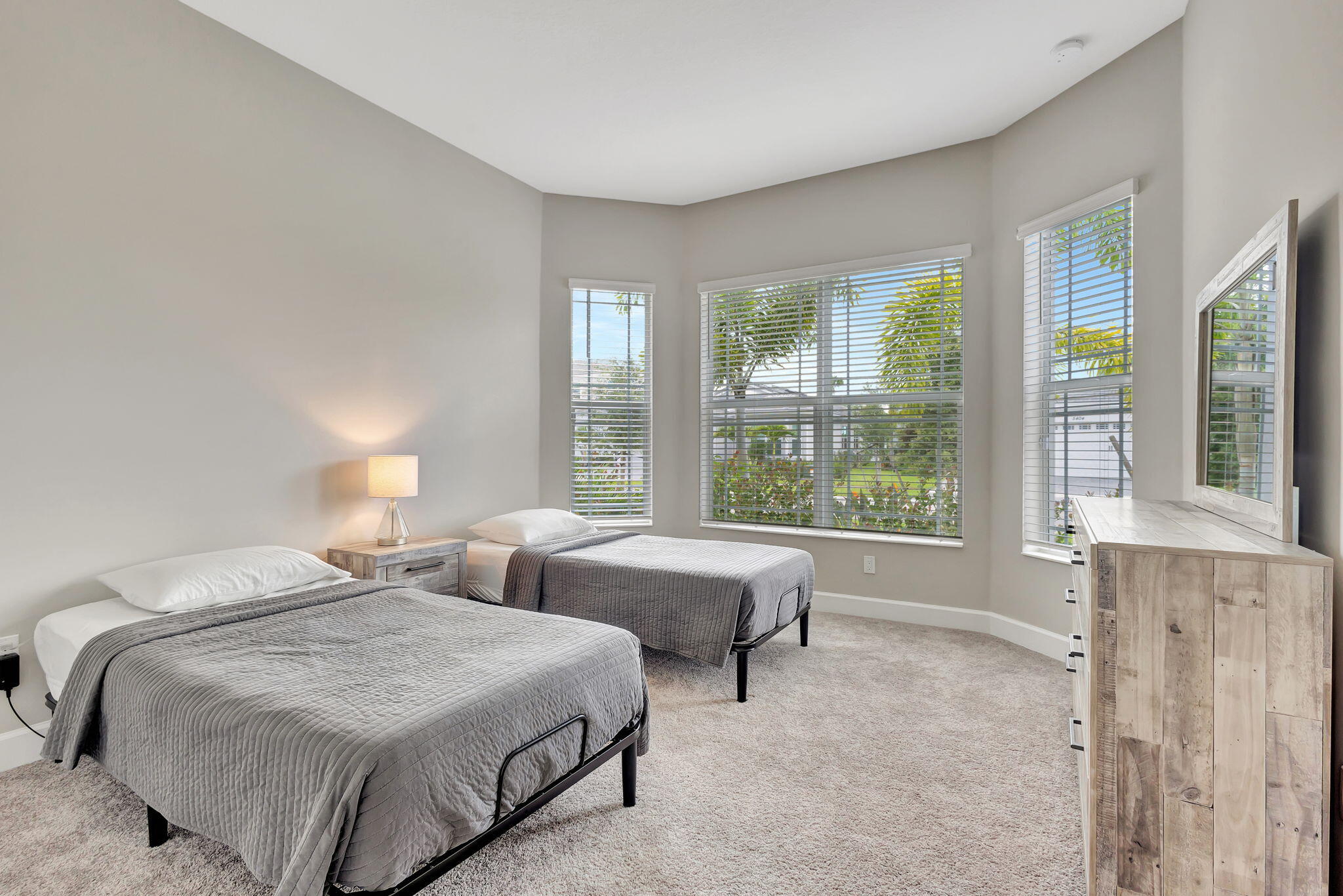 5403 Macoon Way Westlake, FL 33470 - Photo 22 of 51 a spacious bedroom with two beds and a large window