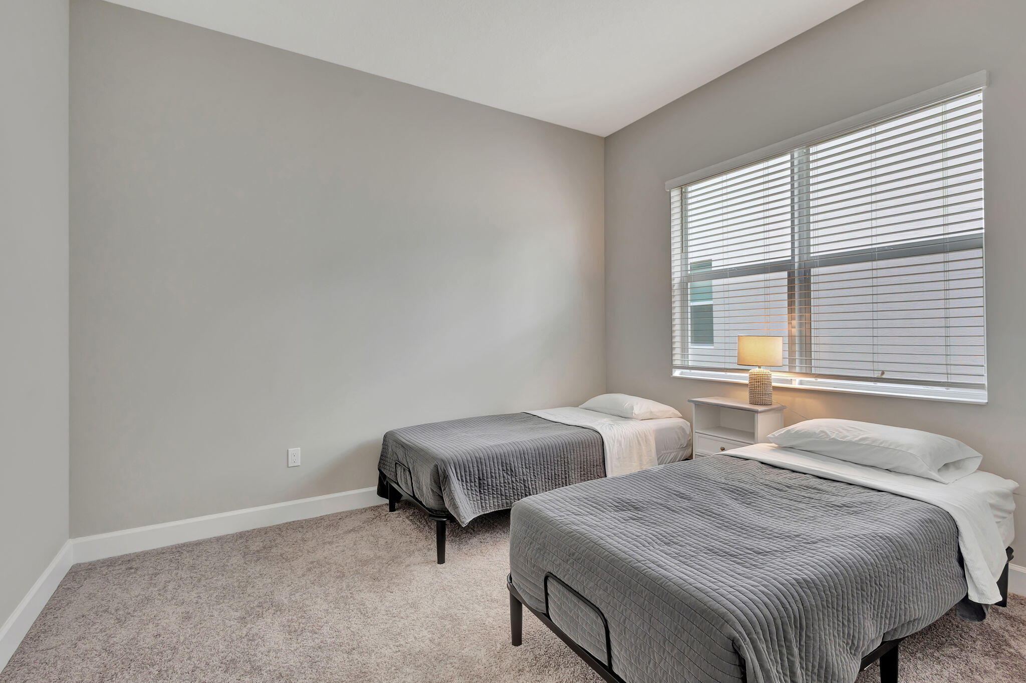 5403 Macoon Way Westlake, FL 33470 - Photo 25 of 51 a bedroom with two beds and a window