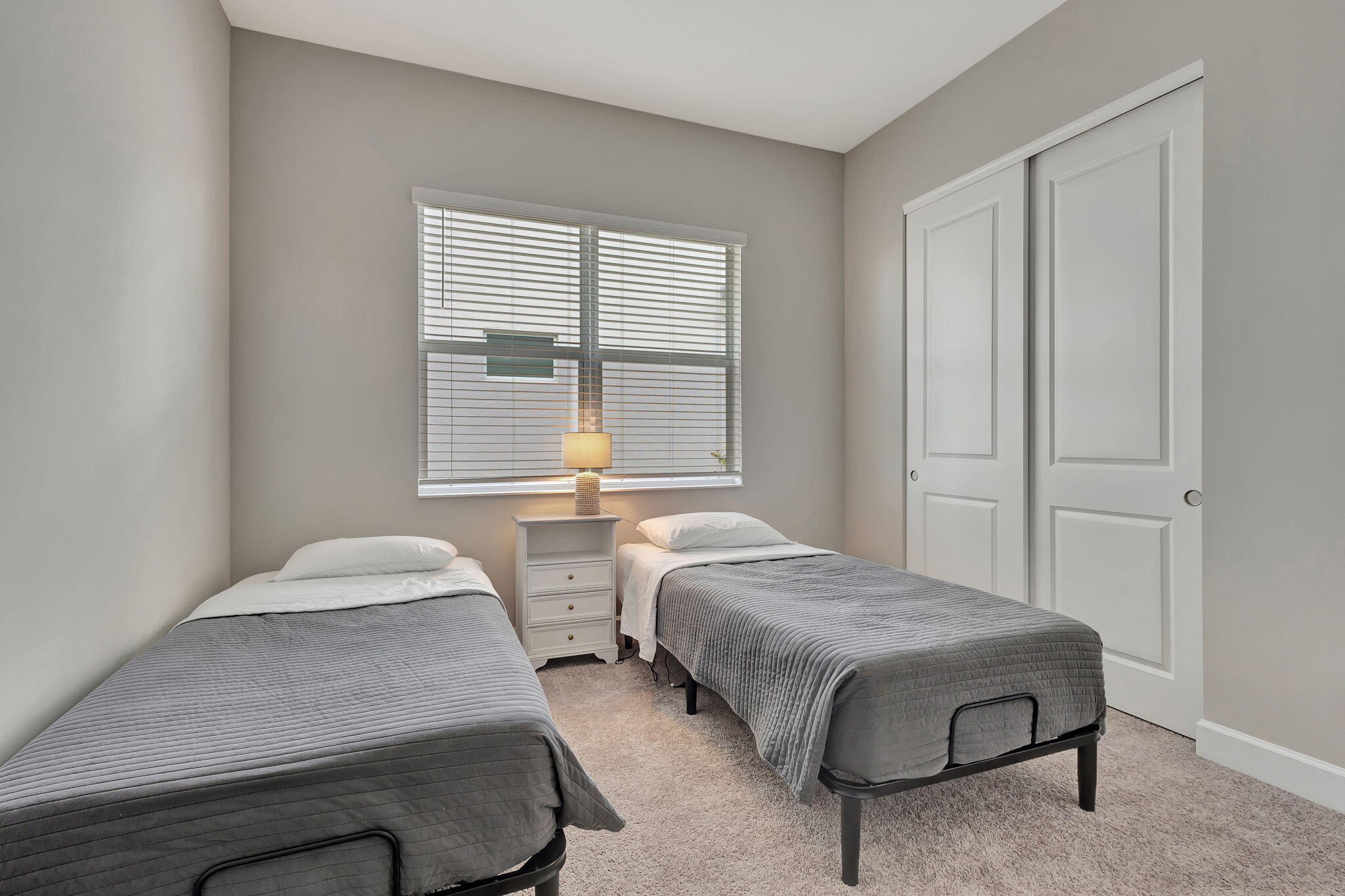 5403 Macoon Way Westlake, FL 33470 - Photo 26 of 51 a bedroom with two beds and a window