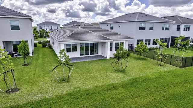a view of house with a yard patio and a garden
