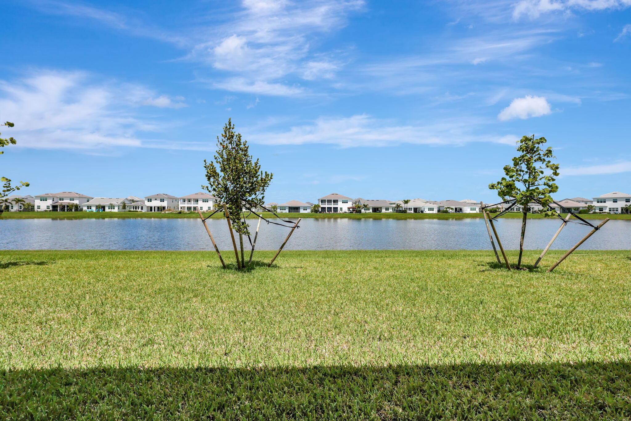 5403 Macoon Way Westlake, FL 33470 - Photo 36 of 51 a view of a lake with houses in the back