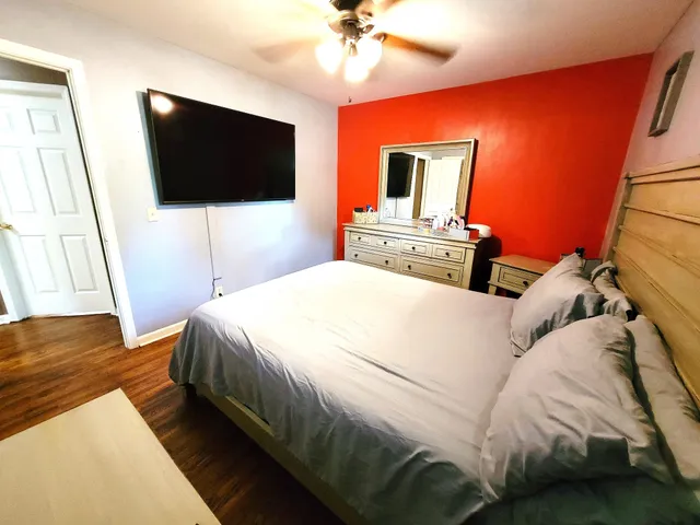 a bedroom with a bed and a flat screen tv