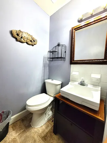 a bathroom with a toilet sink and mirror