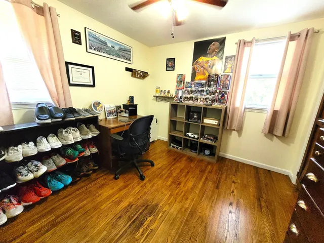 a view of a workspace with furniture and a window