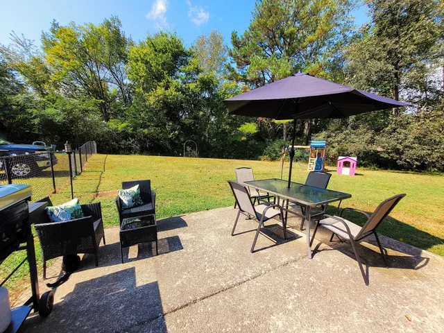 a view of a chairs and table in the patio