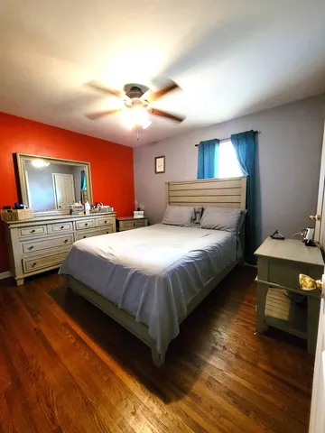 a bedroom with a bed and a mirror