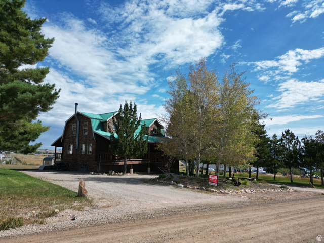 358 Maple Drive Fish Haven, ID 83287 - Photo 3 of 46 Barn-style home with a green metal roof and a stone facade