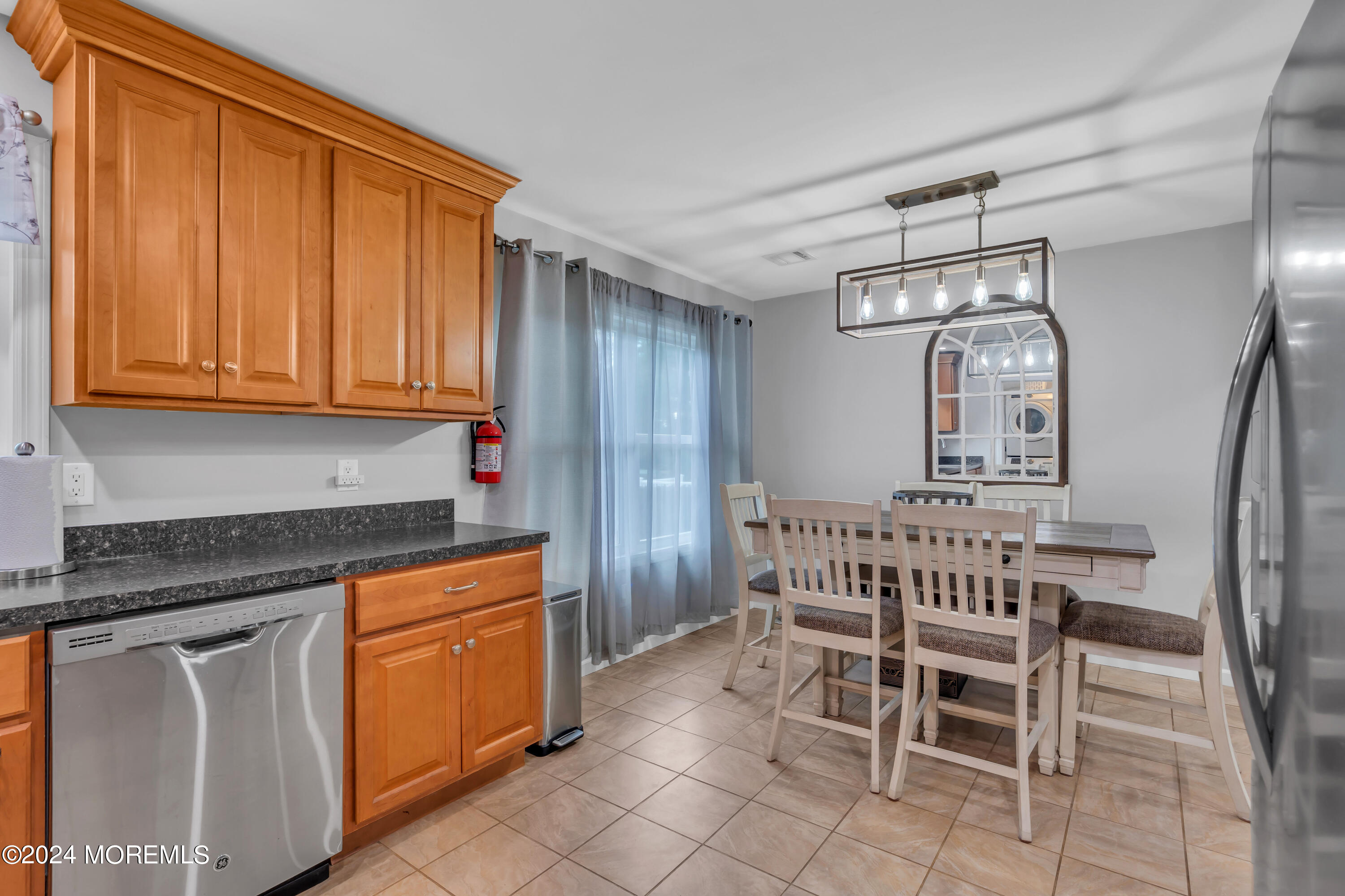172 Stowaway Road Manahawkin, NJ 08050 - Photo 13 of 36 a kitchen with stainless steel appliances granite countertop a white cabinets and a refrigerator