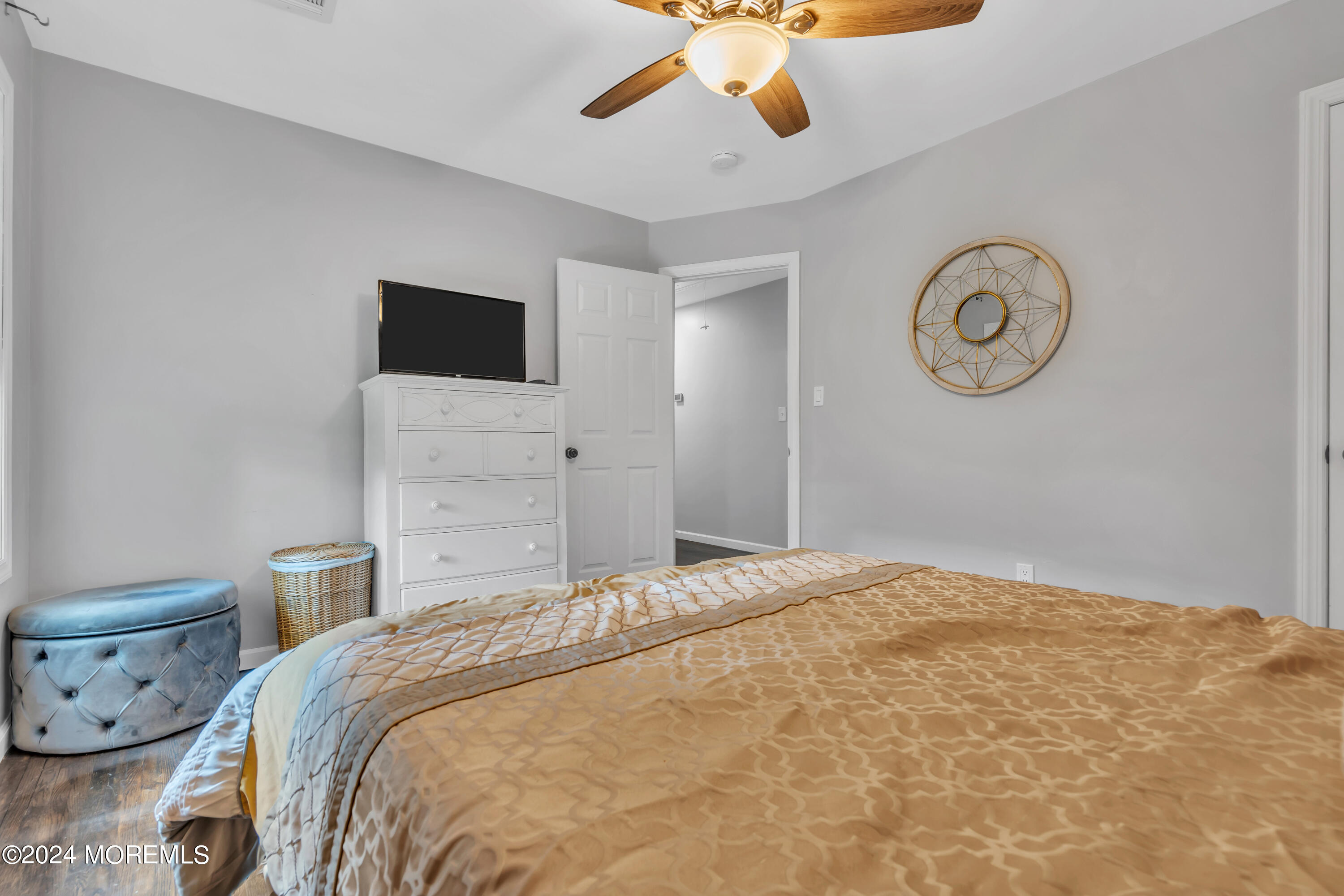 172 Stowaway Road Manahawkin, NJ 08050 - Photo 17 of 36 a bedroom with a bed and a chandelier