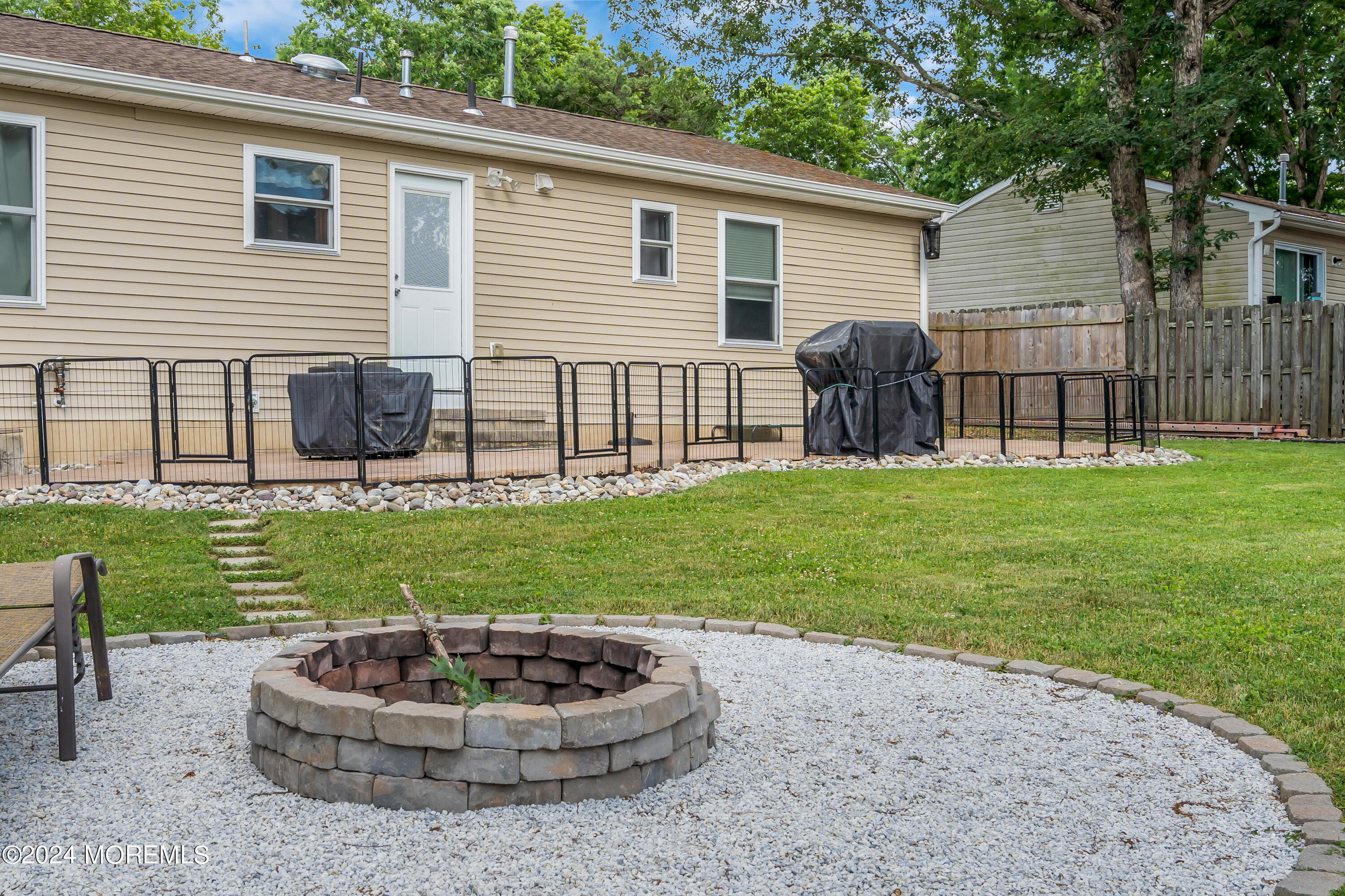 172 Stowaway Road Manahawkin, NJ 08050 - Photo 31 of 36 a house view with a garden space and patio