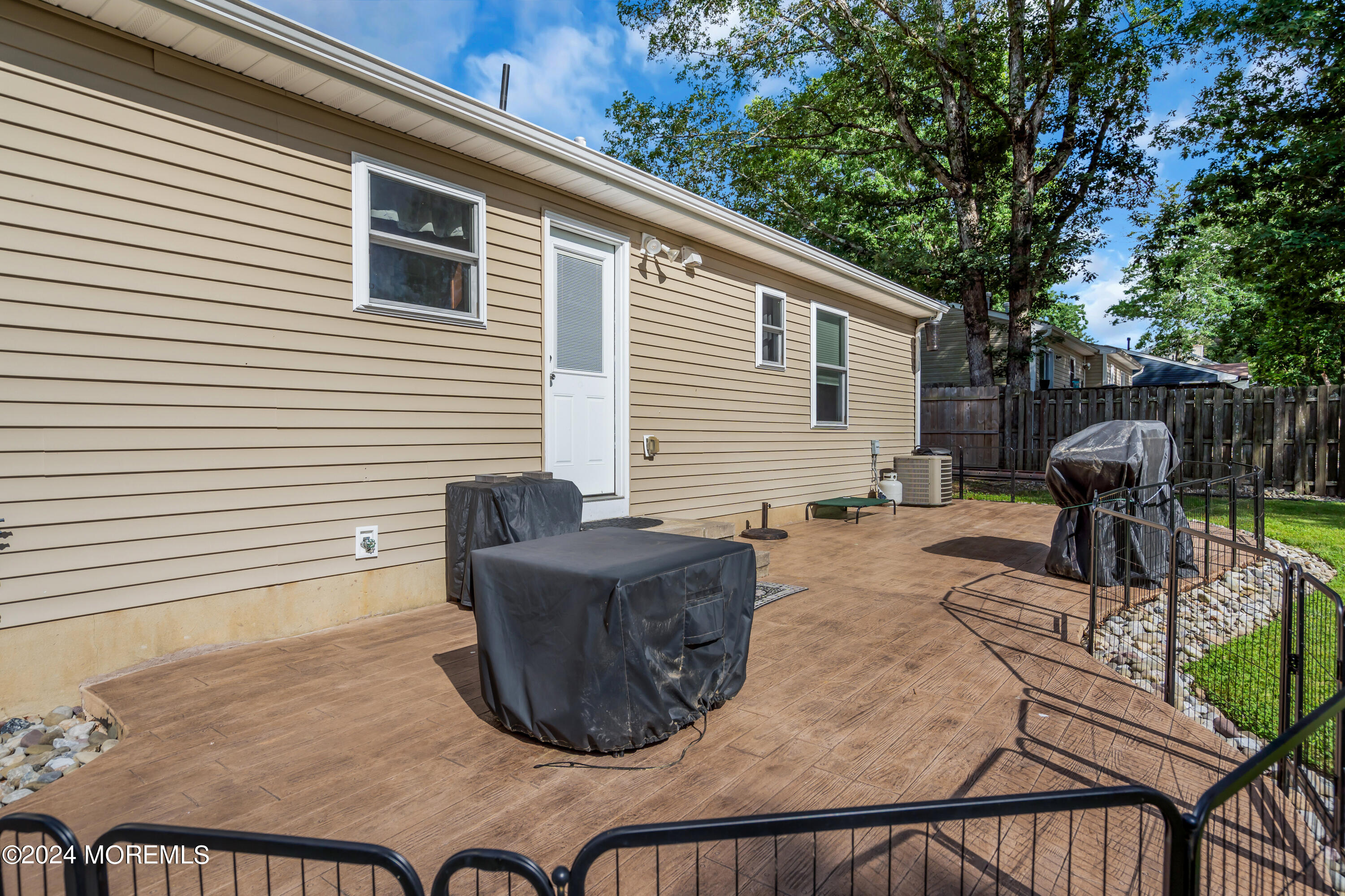 172 Stowaway Road Manahawkin, NJ 08050 - Photo 32 of 36 a view of a patio with table and chairs with wooden floor and fence