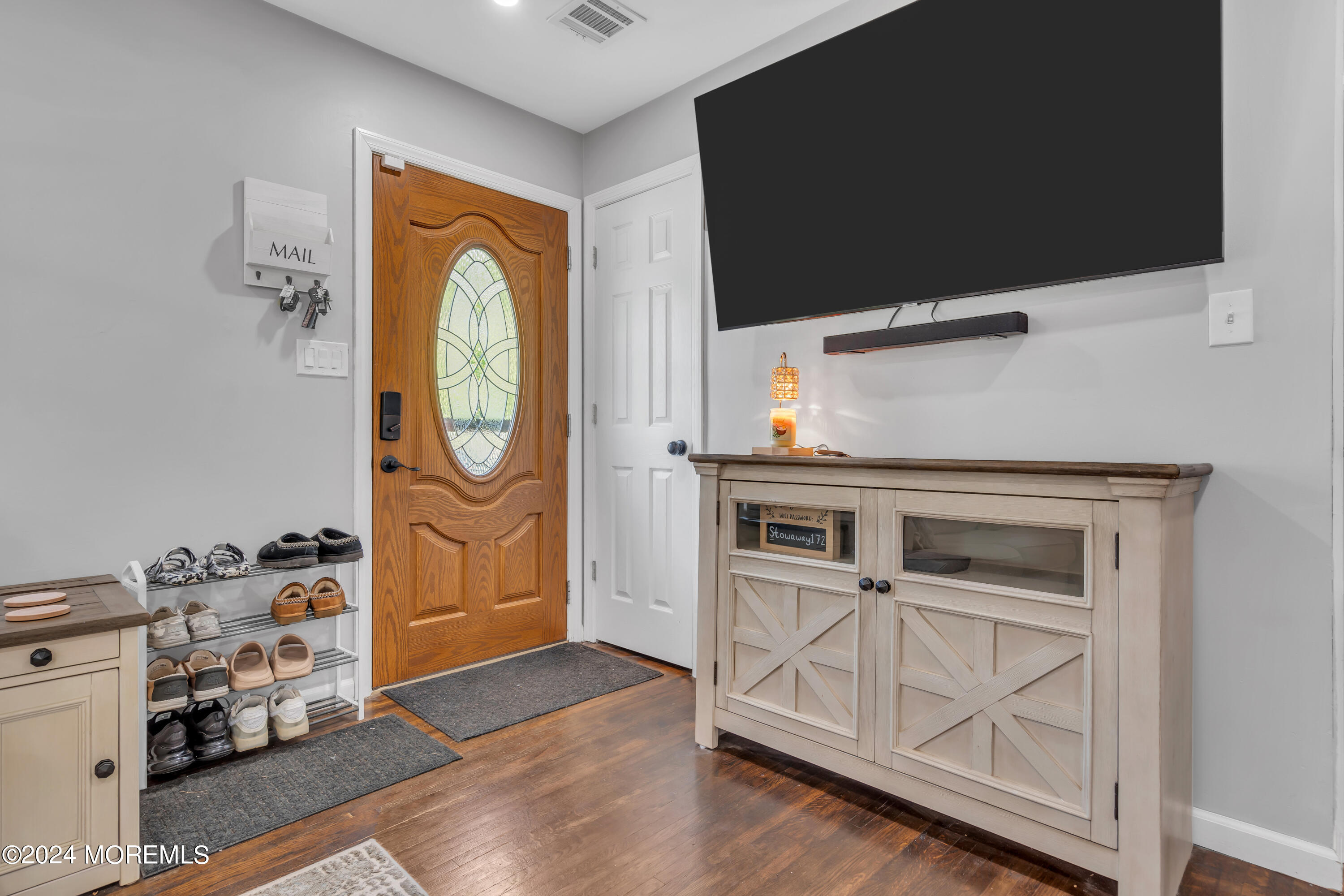 172 Stowaway Road Manahawkin, NJ 08050 - Photo 6 of 36 a kitchen with stainless steel appliances granite countertop a stove and a microwave with wooden floor