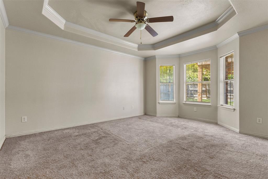 490 Lynne Drive Rockwall, TX 75032 - Photo 13 of 27 Carpeted empty room with a raised ceiling, crown molding, and a ceiling fan