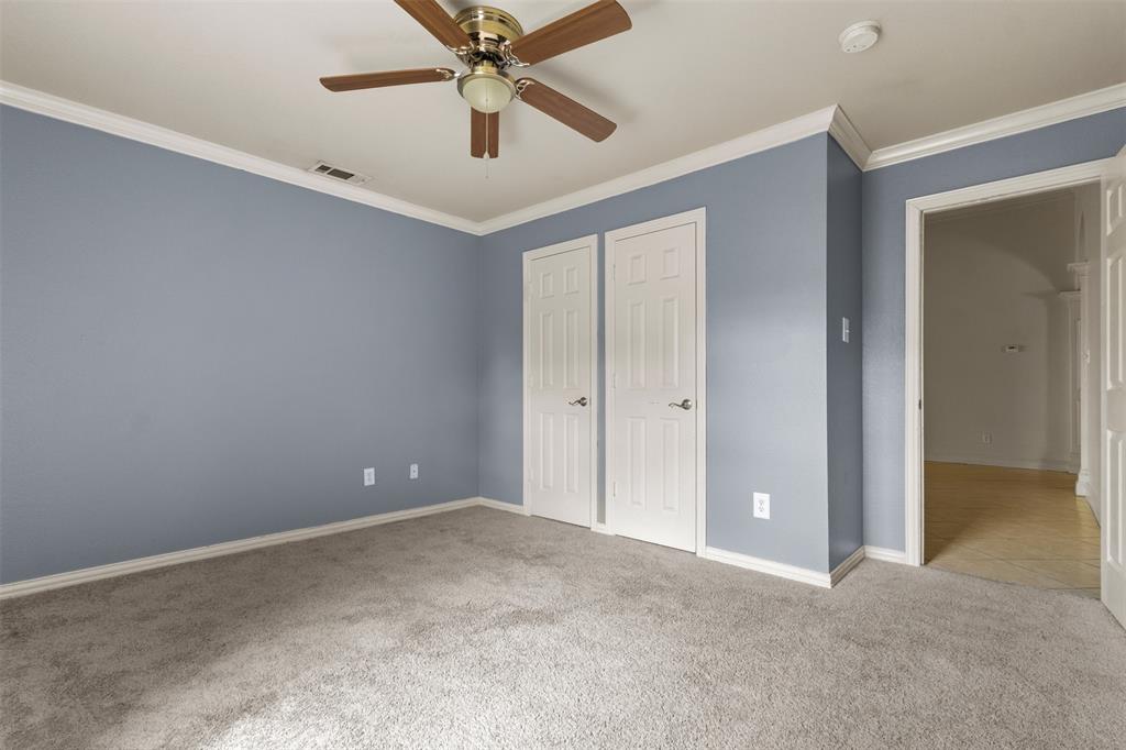 490 Lynne Drive Rockwall, TX 75032 - Photo 23 of 27 Unfurnished bedroom featuring crown molding, light colored carpet, ceiling fan, and a closet