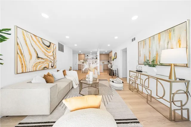 a living room with furniture cabinets and a table