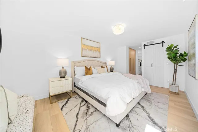 a bedroom with a bed and a potted plant