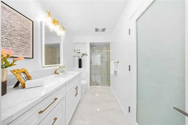 a spacious bathroom with a double vanity sink and mirror