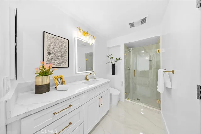 a bathroom with a double vanity sink a mirror a shower and a bathtub