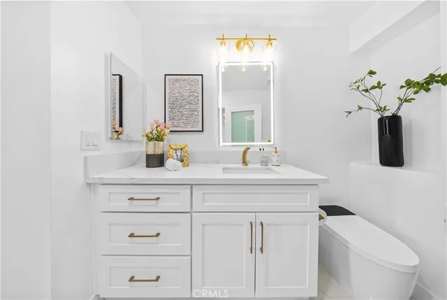 a bathroom with a sink a toilet and mirror
