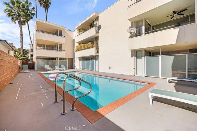 a swimming pool with outdoor seating and yard
