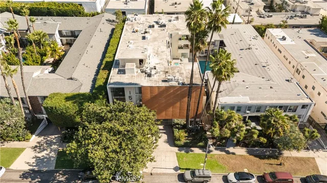 a front view of a house with a garden and trees