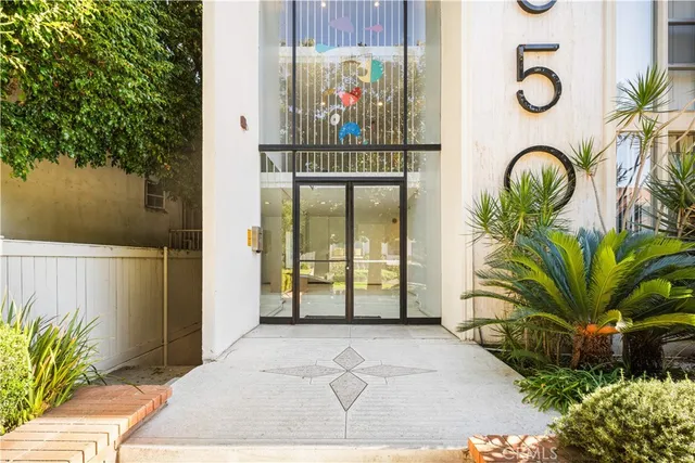 a view of kitchen with refrigerator and window