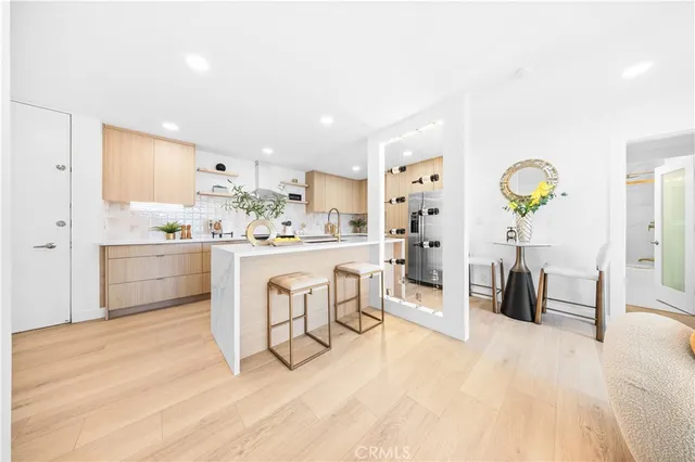 a kitchen with stainless steel appliances a white cabinets counter space and a sink