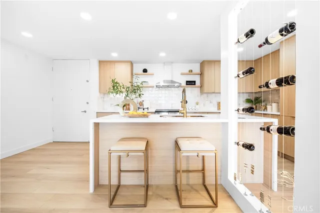 a white kitchen with a sink cabinets and stainless steel appliances