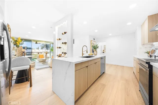 a large white kitchen with a large window