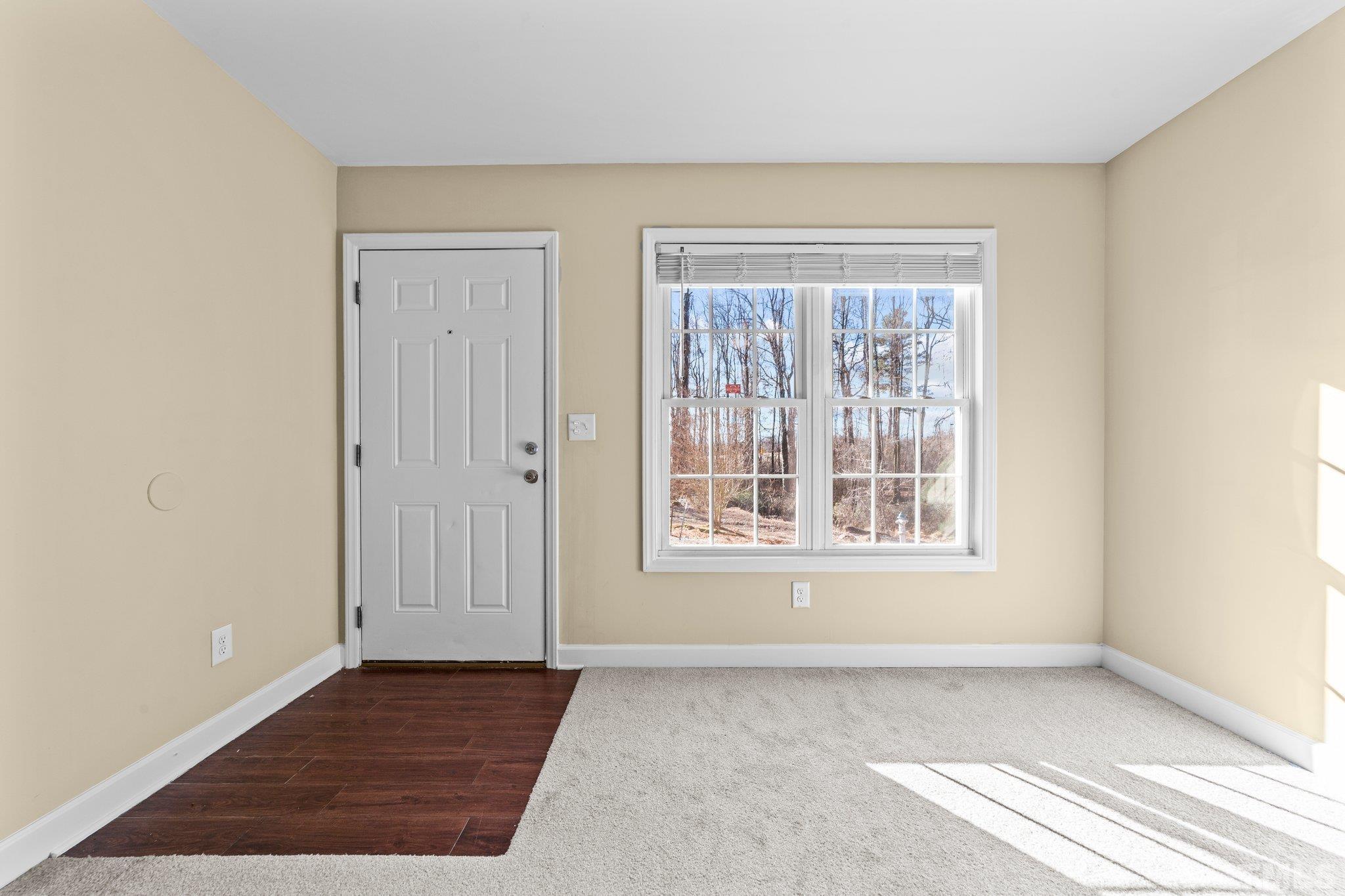 198 Garrett Street Roxboro, NC 27573 - Photo 11 of 17 an empty room with wooden floor and windows