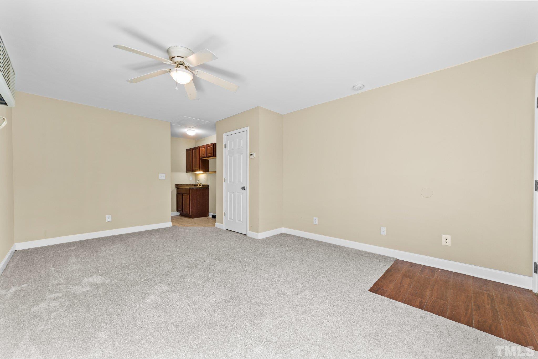 198 Garrett Street Roxboro, NC 27573 - Photo 13 of 17 an empty room with a view of a kitchen