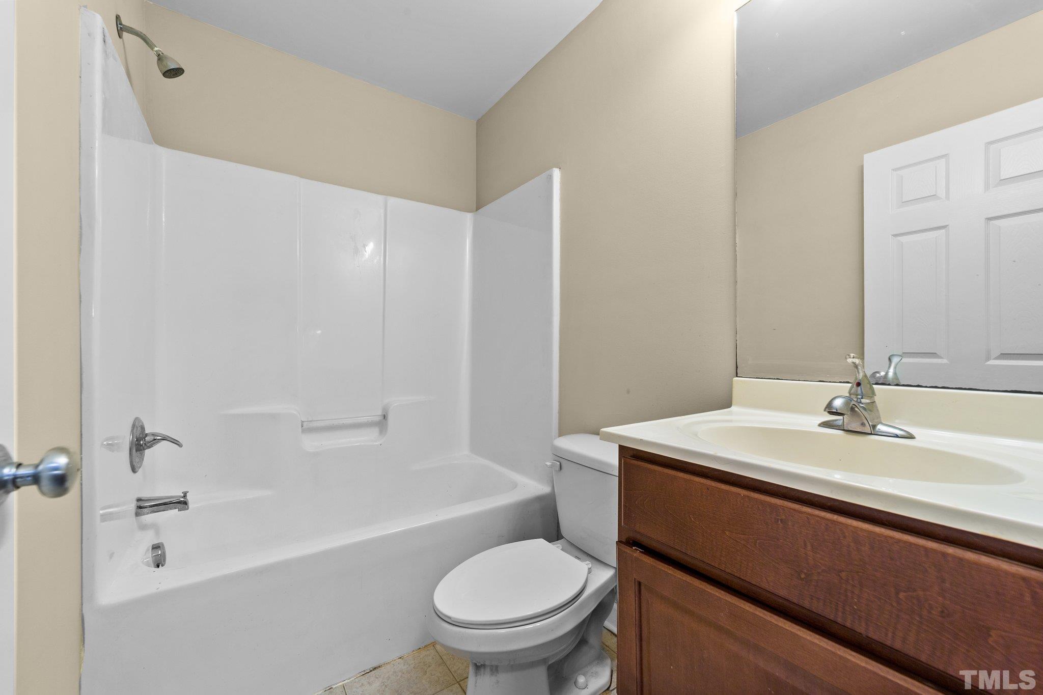 198 Garrett Street Roxboro, NC 27573 - Photo 17 of 17 a bathroom with a sink a toilet and a bathtub