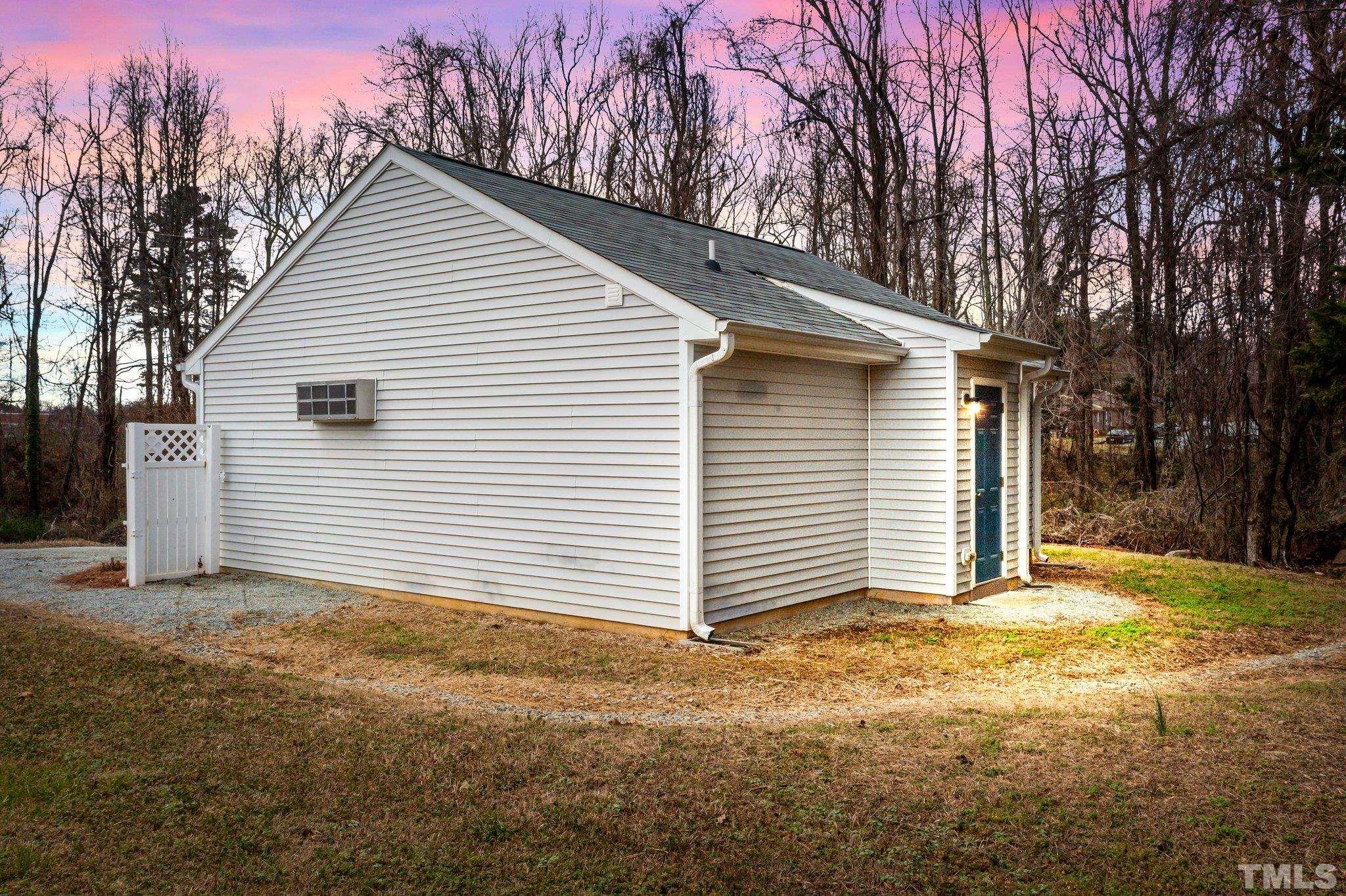 198 Garrett Street Roxboro, NC 27573 - Photo 2 of 17 a view of a house with a yard and garage