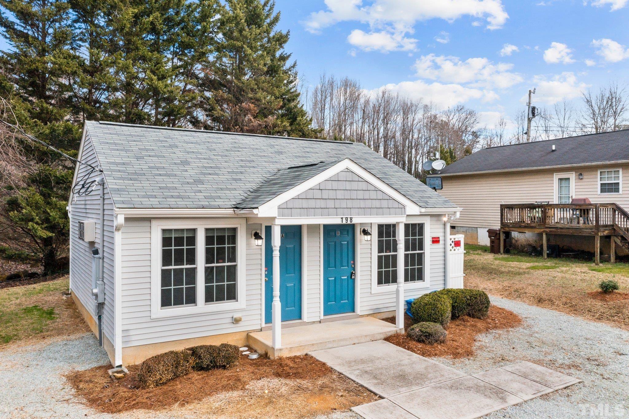 198 Garrett Street Roxboro, NC 27573 - Photo 3 of 17 a front view of a house with garden