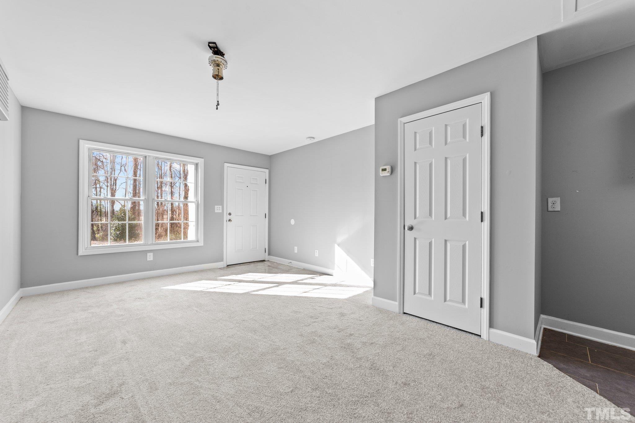 198 Garrett Street Roxboro, NC 27573 - Photo 7 of 17 a view of empty room with windows