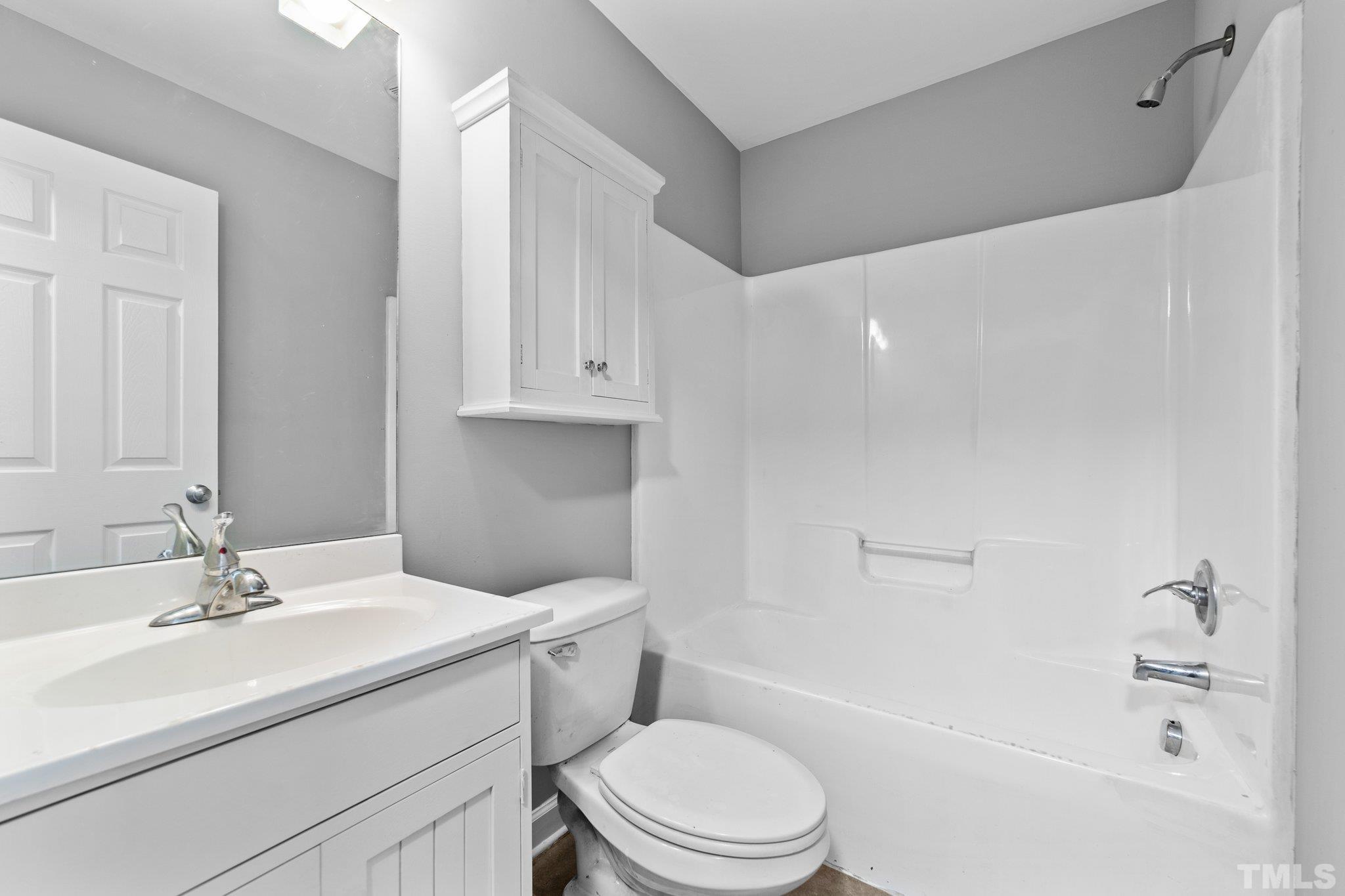 198 Garrett Street Roxboro, NC 27573 - Photo 9 of 17 a bathroom with a sink a toilet and a bathtub