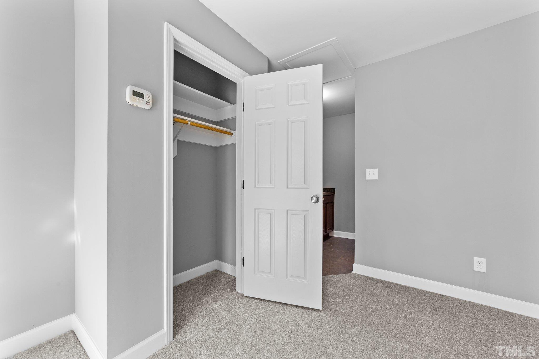 198 Garrett Street Roxboro, NC 27573 - Photo 10 of 17 an empty room with closet and wooden door