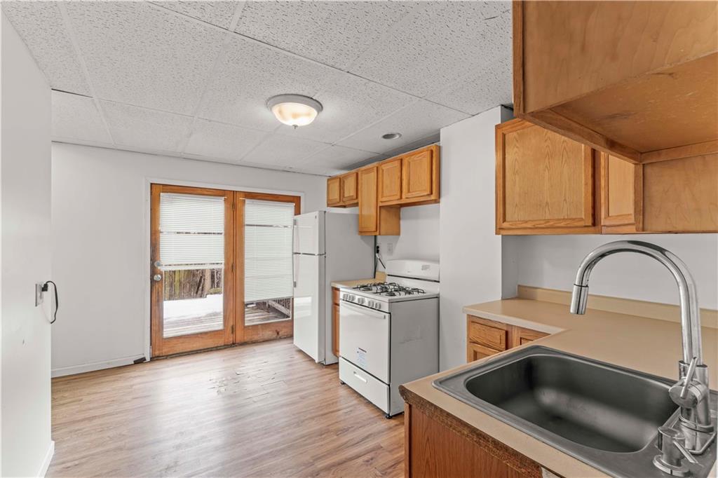1877 Chapman Street Pittsburgh, PA 15215 - Photo 12 of 28 a kitchen with a stove a sink and a microwave