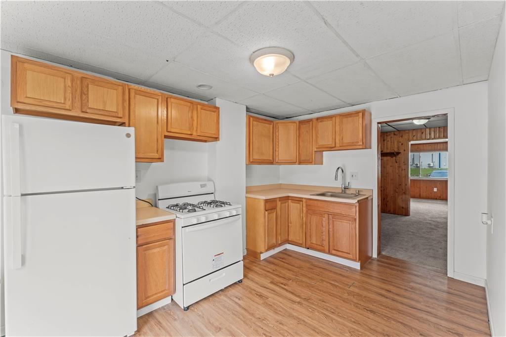 1877 Chapman Street Pittsburgh, PA 15215 - Photo 13 of 28 a kitchen with a refrigerator sink and cabinets