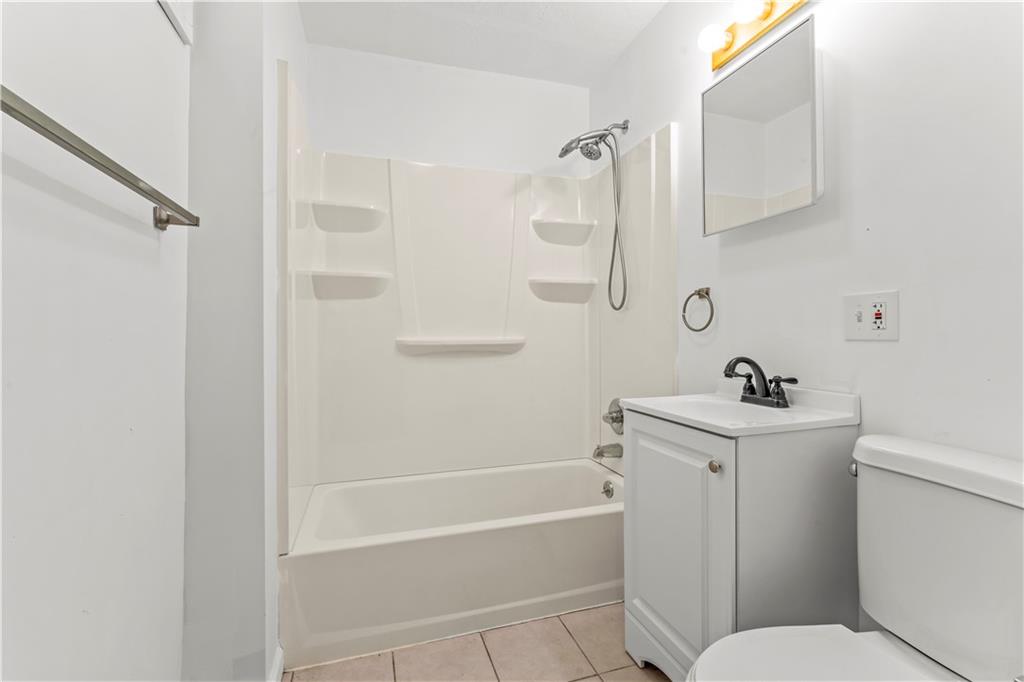 1877 Chapman Street Pittsburgh, PA 15215 - Photo 15 of 28 a bathroom with a sink a toilet and shower
