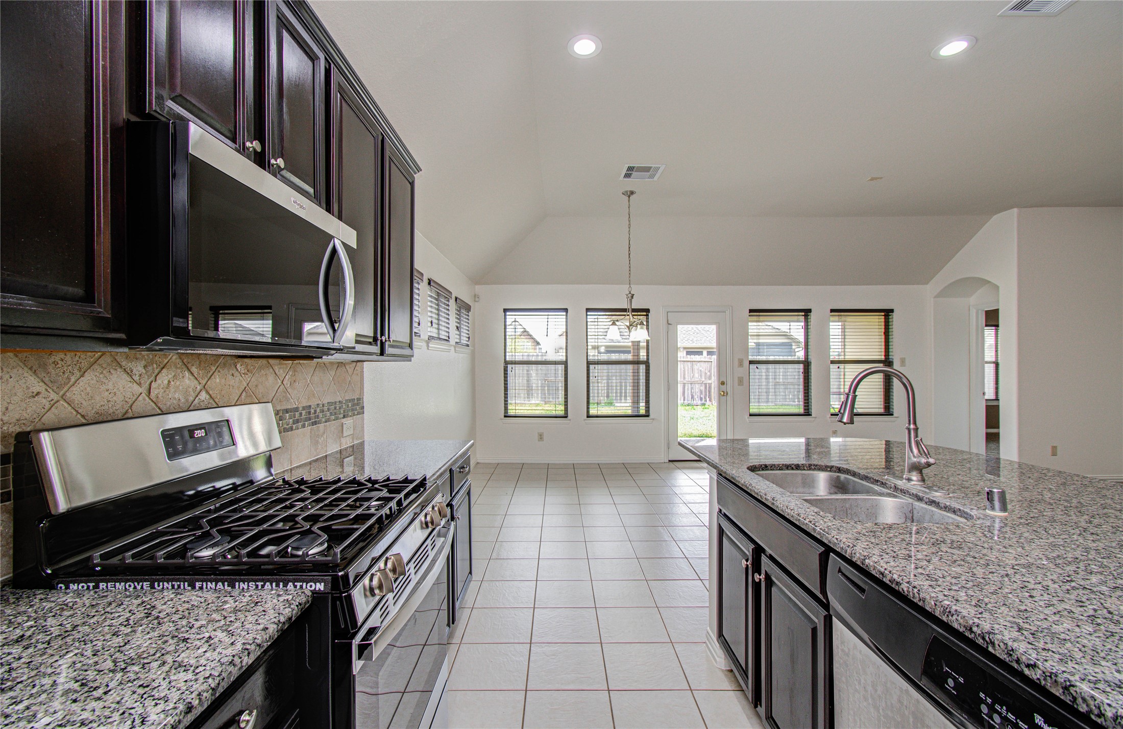 17702 Jacobs Ladder Court Tomball, TX 77377 - Photo 15 of 36 a kitchen with granite countertop a sink a stove and cabinets