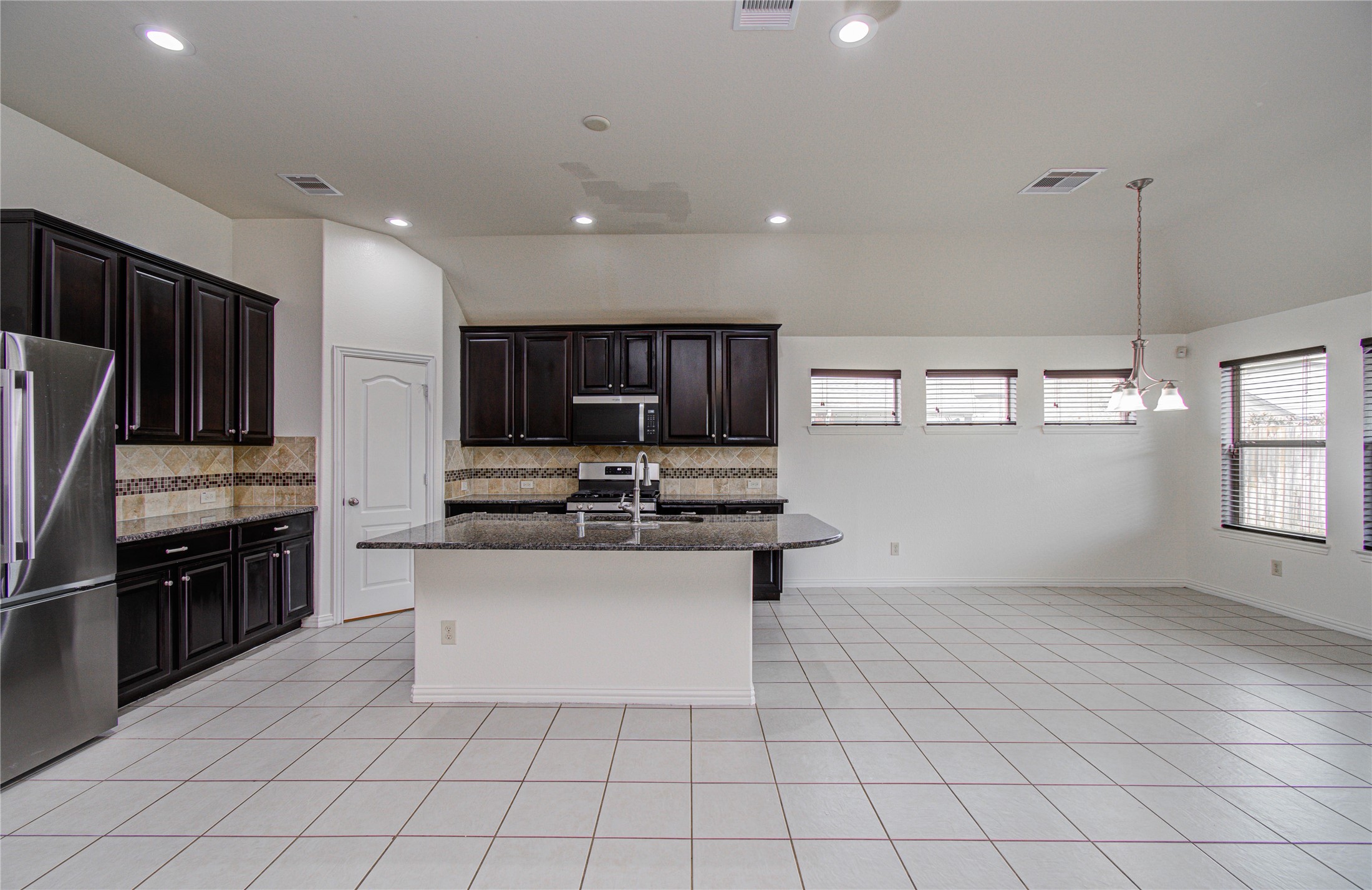 17702 Jacobs Ladder Court Tomball, TX 77377 - Photo 16 of 36 a kitchen with stainless steel appliances a sink stove and cabinets