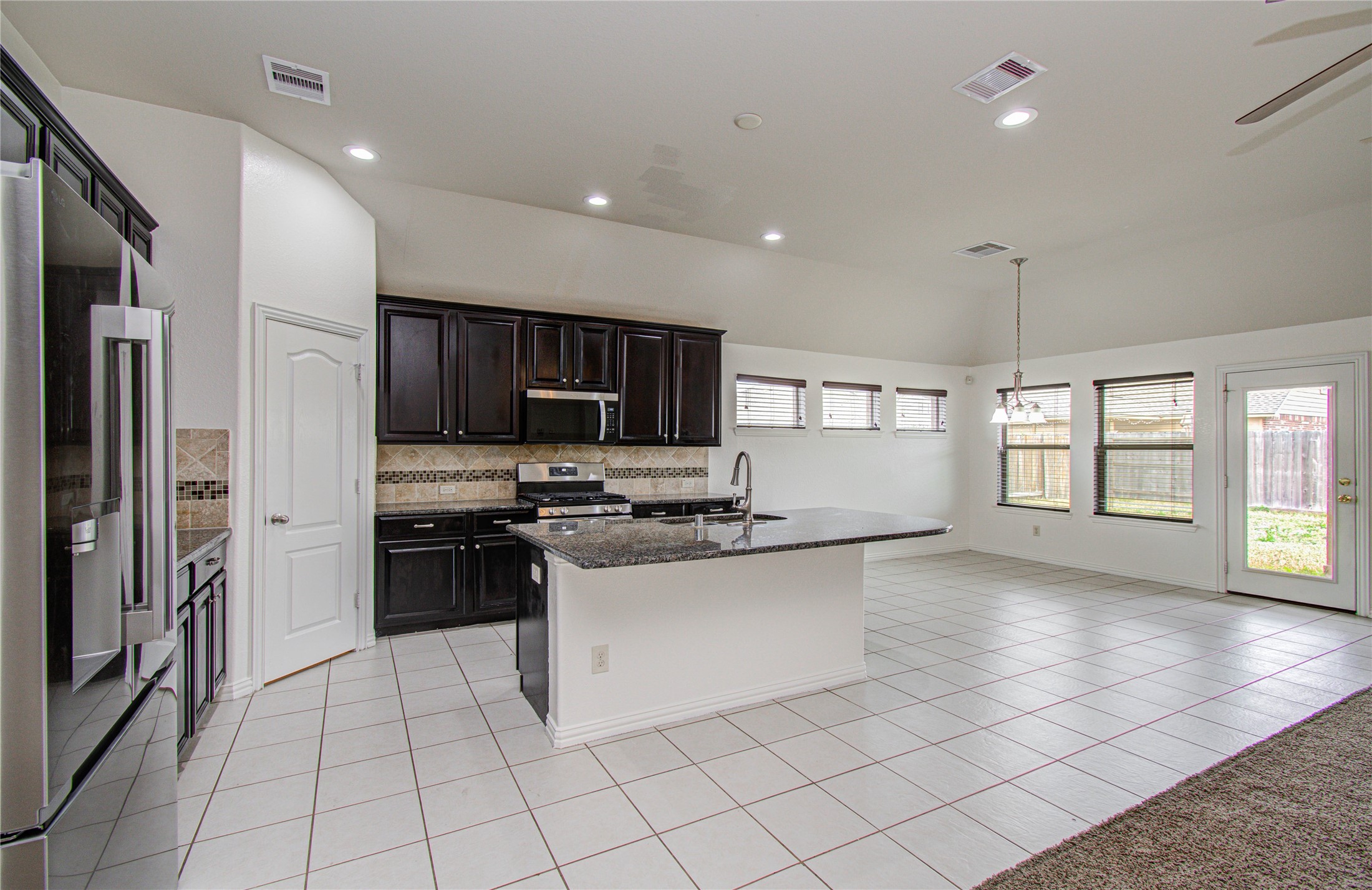 17702 Jacobs Ladder Court Tomball, TX 77377 - Photo 17 of 36 a kitchen with stainless steel appliances a refrigerator sink stove microwave and cabinets