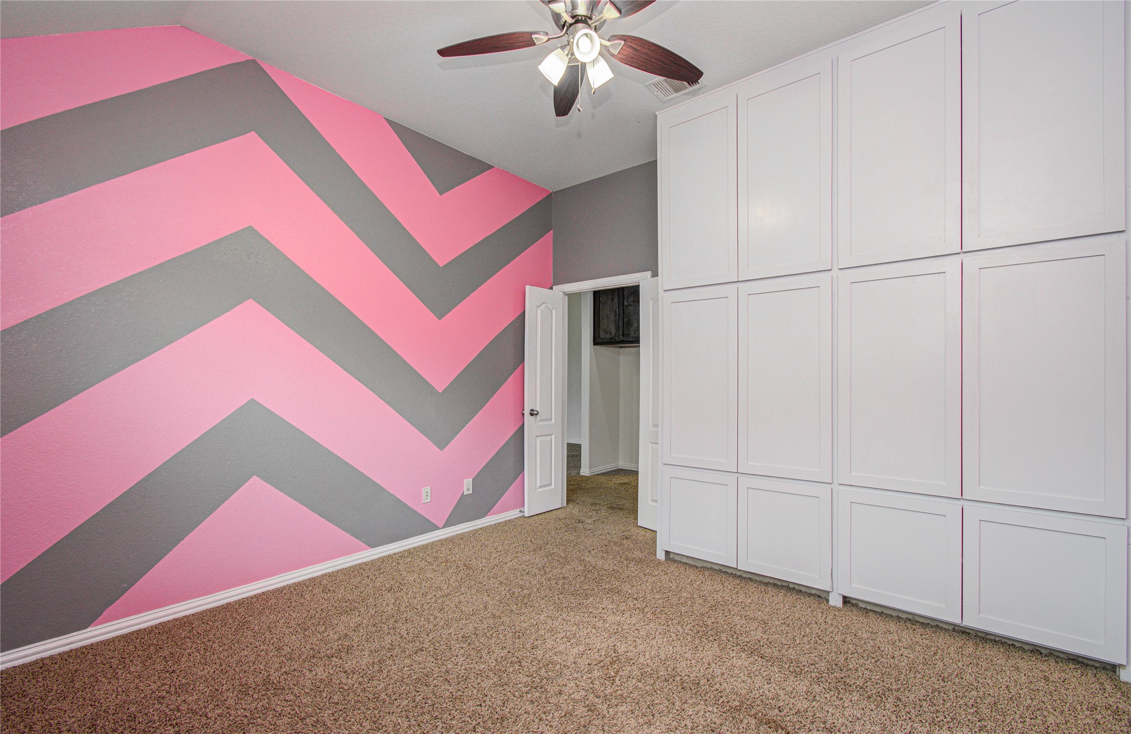 17702 Jacobs Ladder Court Tomball, TX 77377 - Photo 26 of 36 a view of a bedroom with cabinet and chandelier