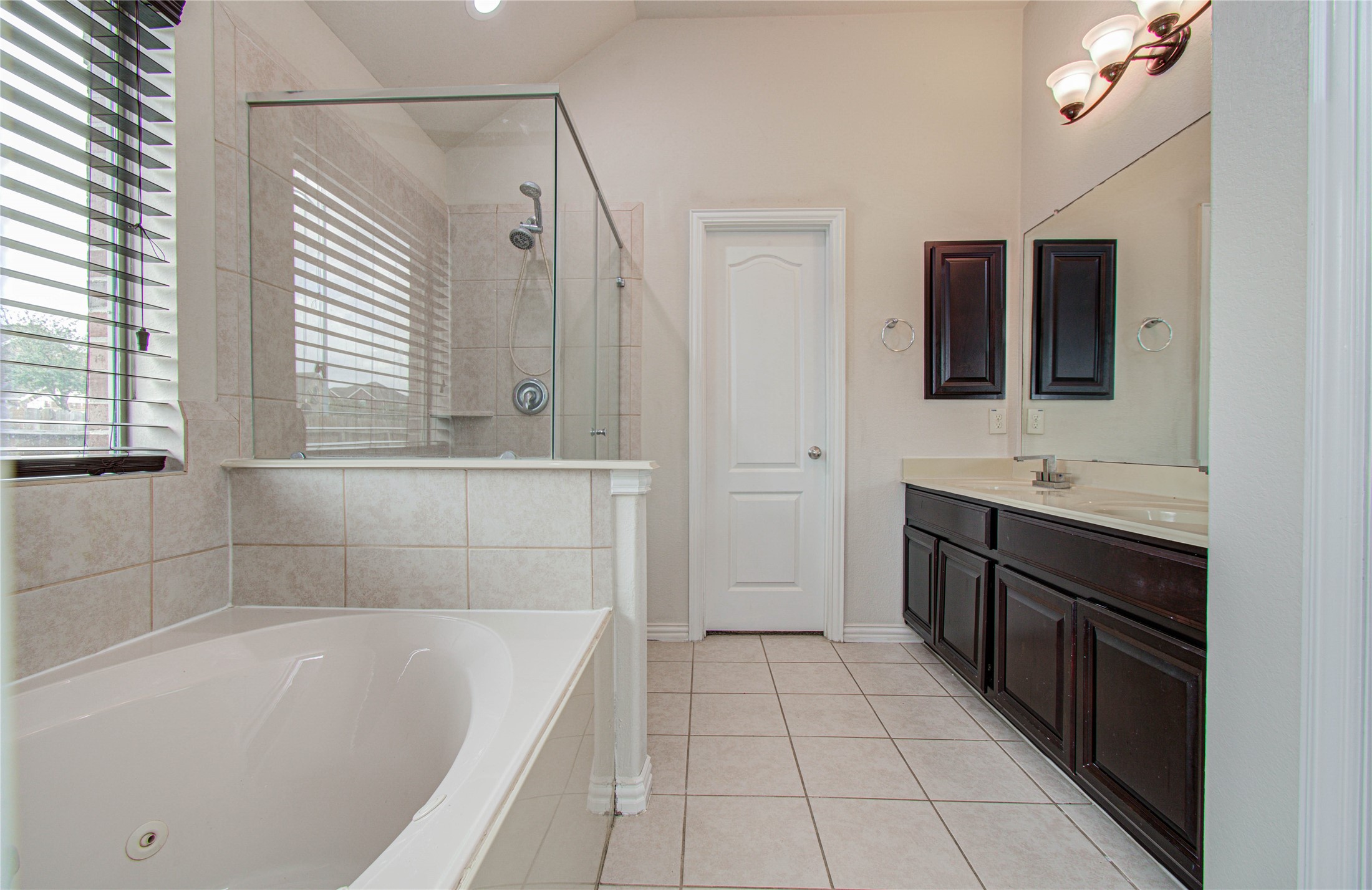 17702 Jacobs Ladder Court Tomball, TX 77377 - Photo 28 of 36 a bathroom with a tub sink and mirror
