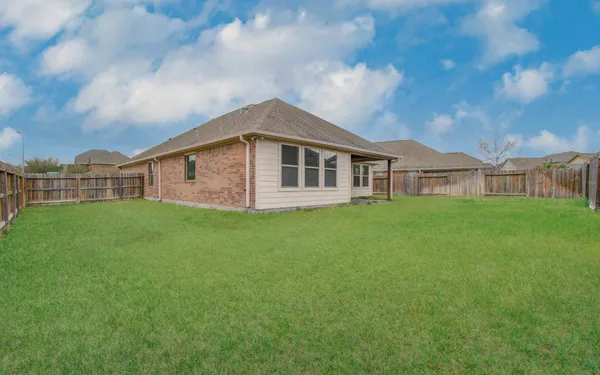 a view of a house with a backyard